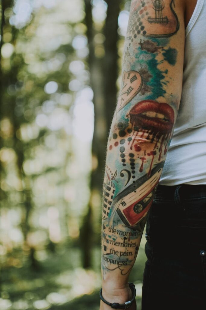 Detailed tattoo sleeve on an arm with outdoor forest background.