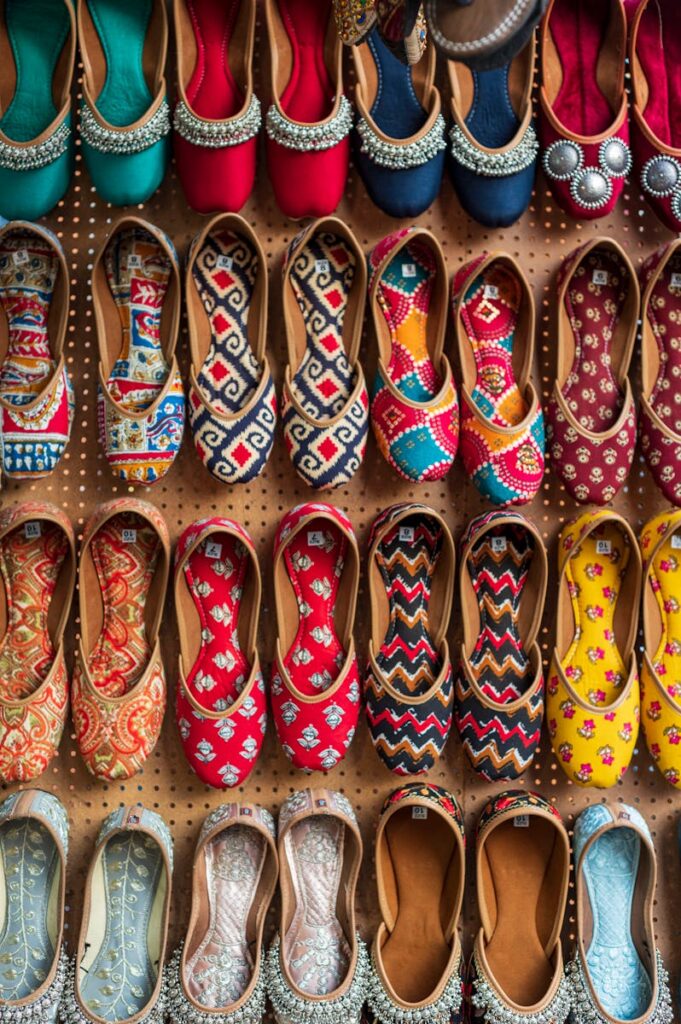 Vibrant display of traditional embroidered footwear in a Jaipur store.
