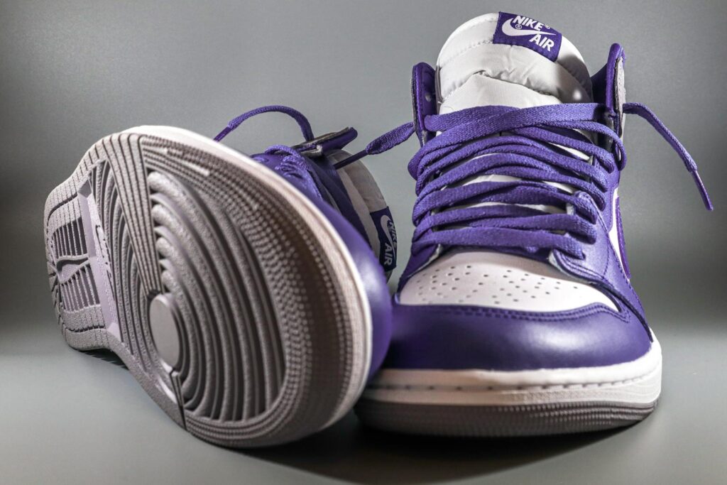 Stylish close-up of purple Nike Air Jordan 1 sneakers showcasing trendy streetwear fashion.