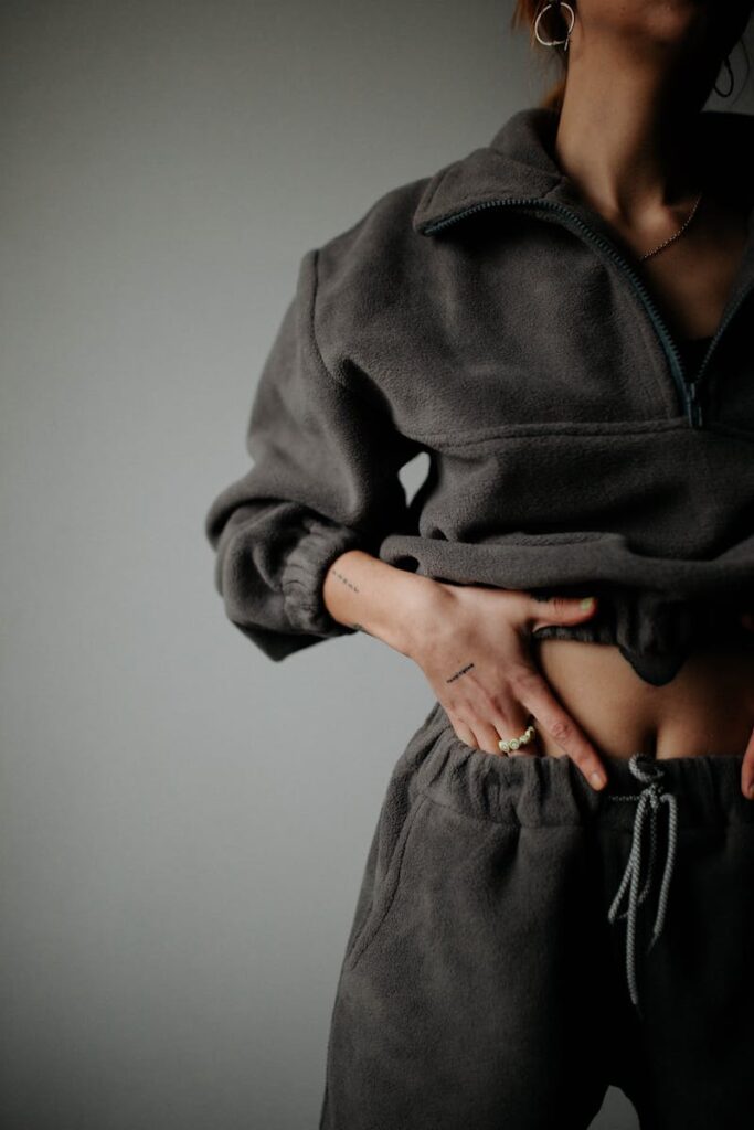 Stylish portrait of a woman showcasing a chic charcoal sweatshirt outfit, emphasizing cozy fashion.