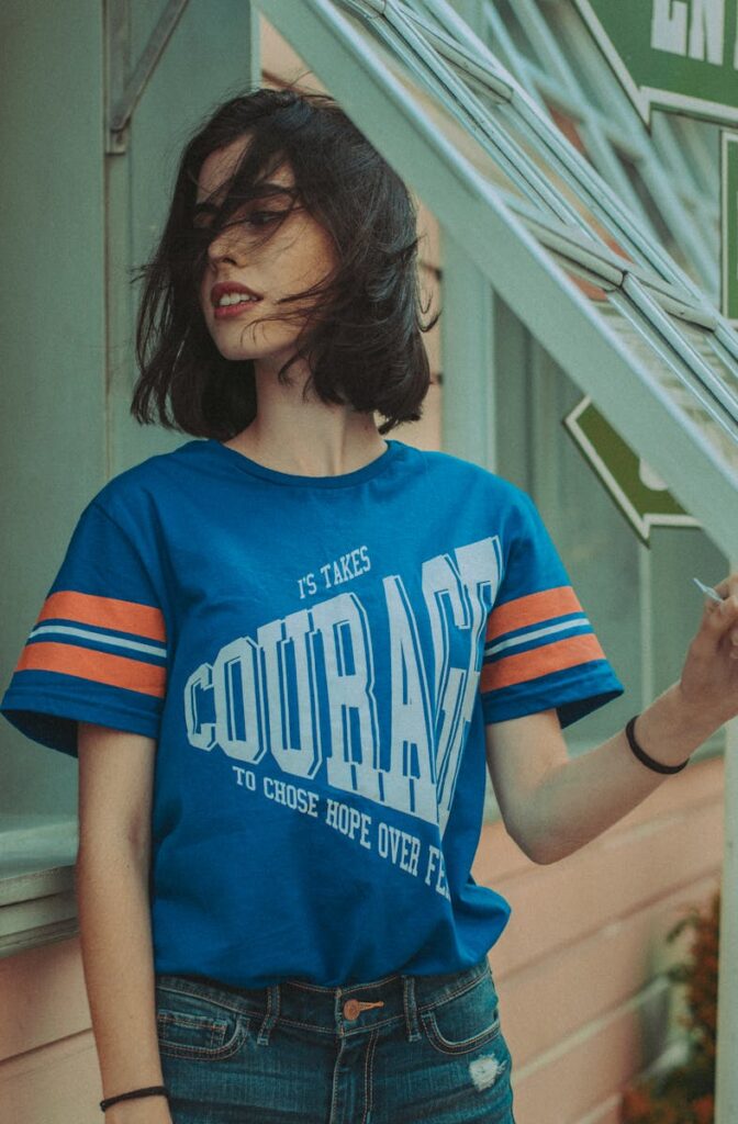 Fashionable woman with short black hair posing outdoors, in casual chic style.