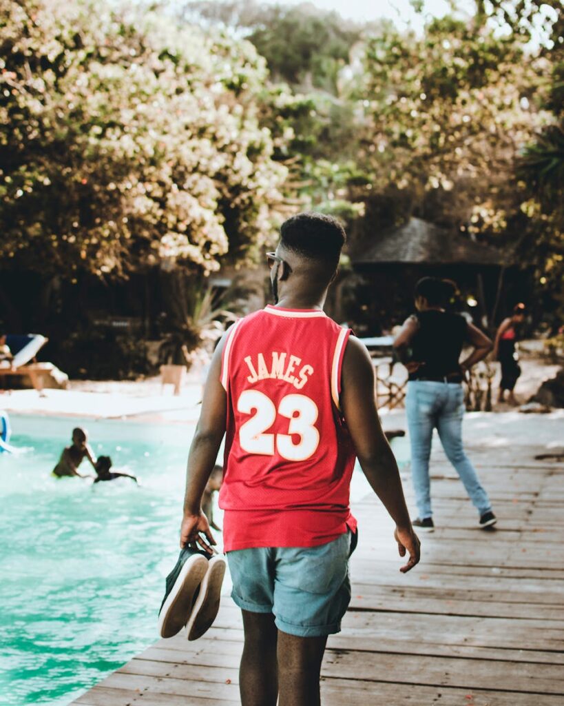 A man enjoying leisure time by the pool in Malindi, Kenya. Perfect for summer lifestyle imagery.