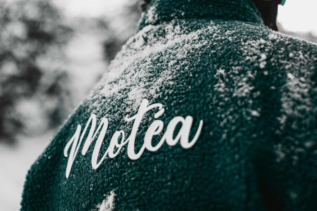 Close-up of a teal jacket with snow and Motéa branding in Brezovica, Serbia.
