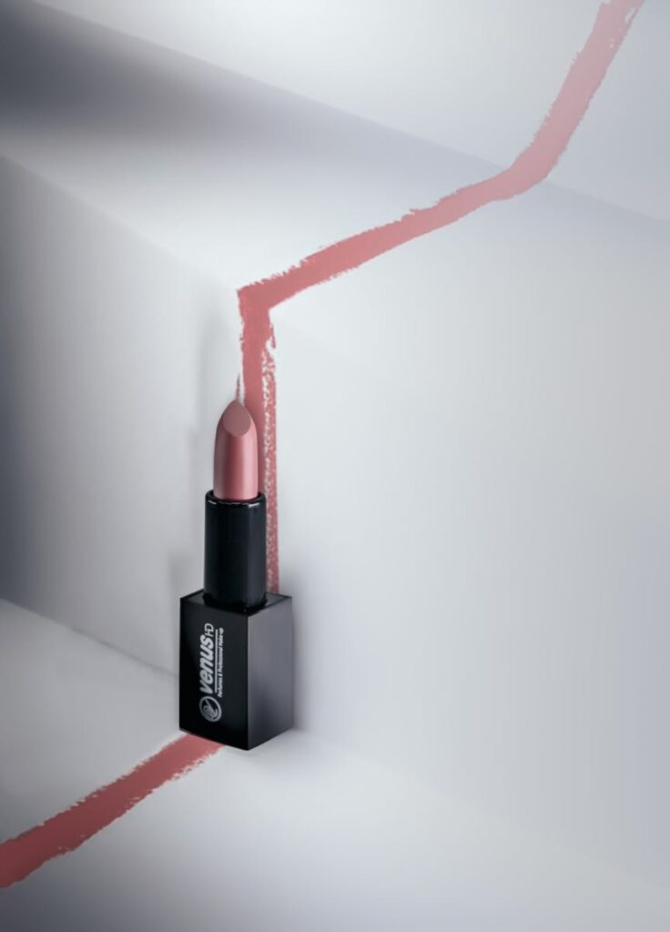 Stylish lipstick displayed on a unique geometric background with artistic lines.