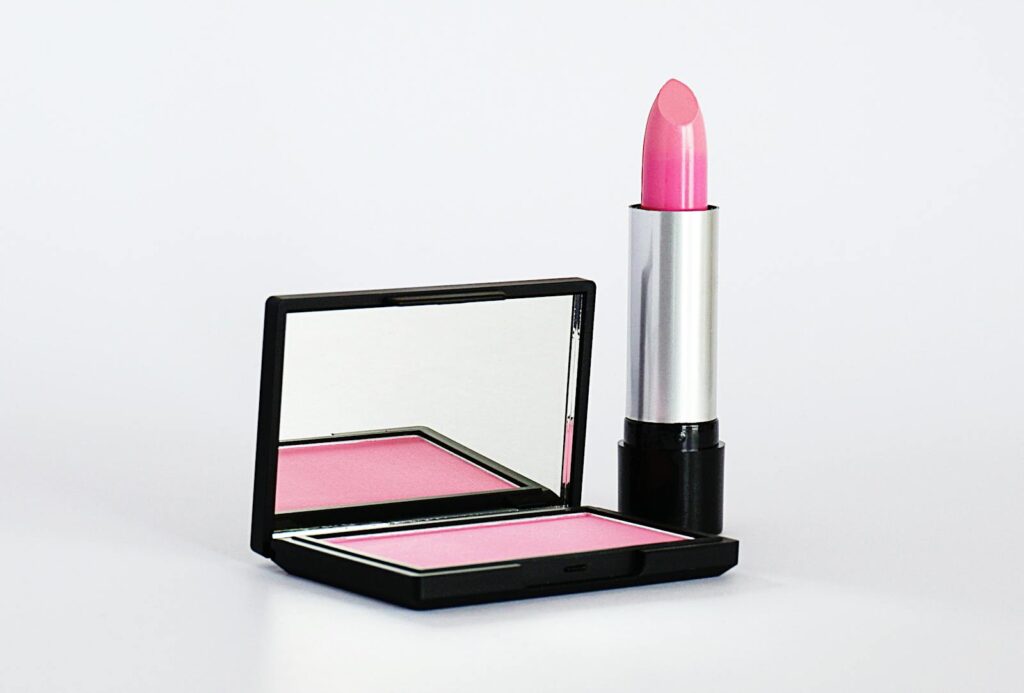Stylish pink lipstick and blush makeup set on a white background, perfect for beauty and cosmetics branding.