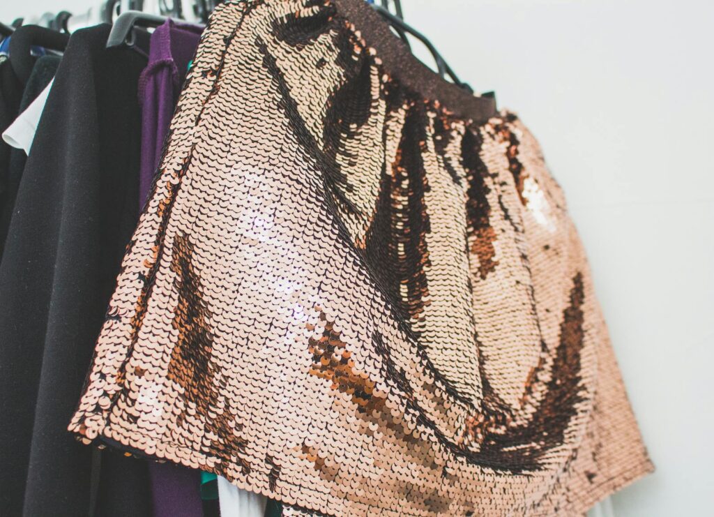 Stylish sequin skirt hanging on a rack. Perfect for fashion-forward wardrobes.