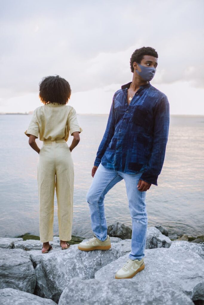 Fashionable couple wearing denim near the New York City waterfront during sunset.