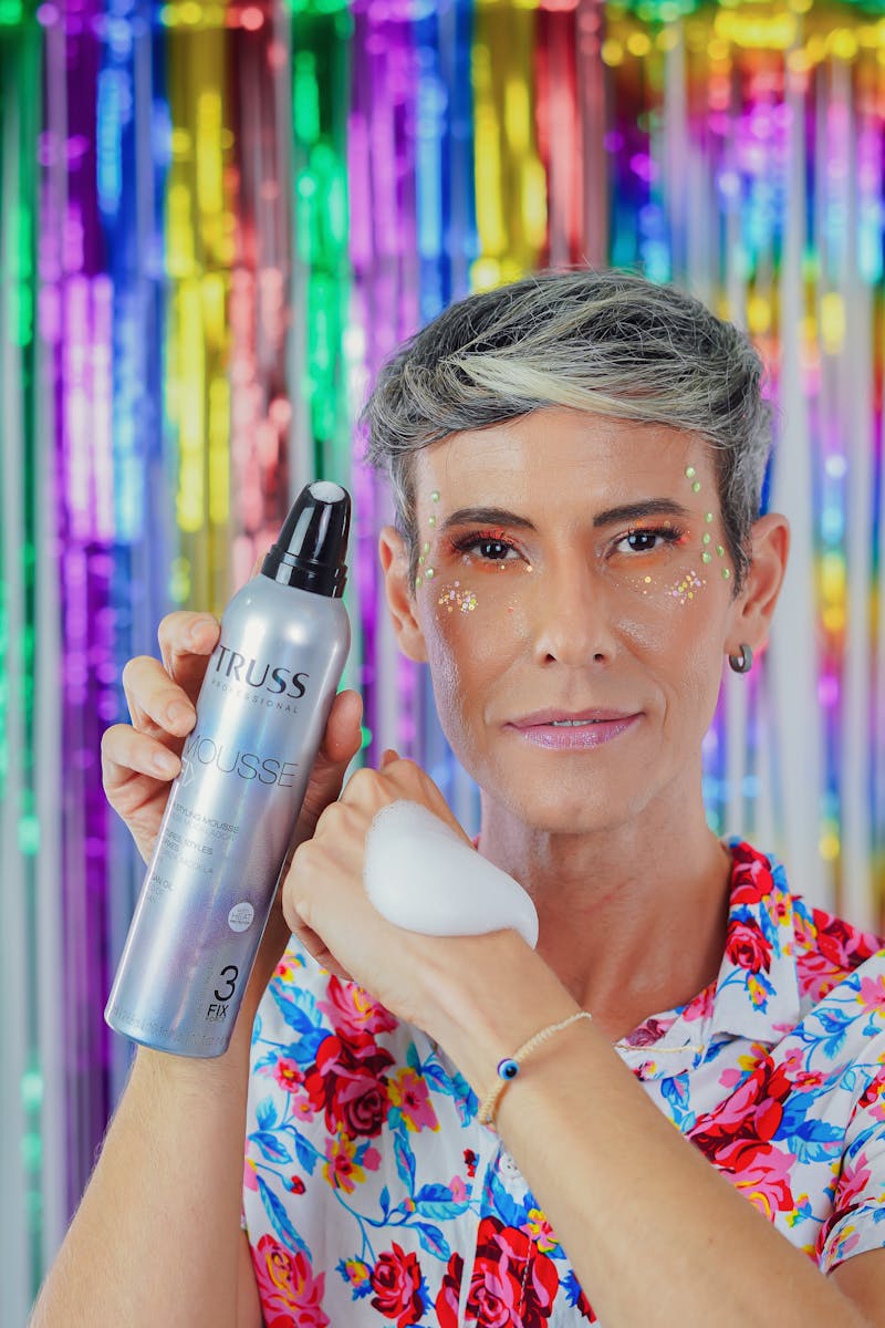 Colorful portrait with glitter and mousse on bright background.