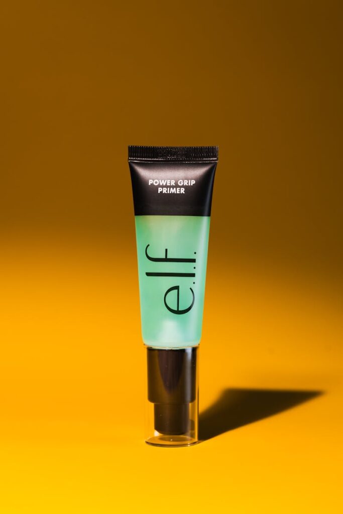E.l.f. Power Grip primer showcased against vibrant yellow backdrop.