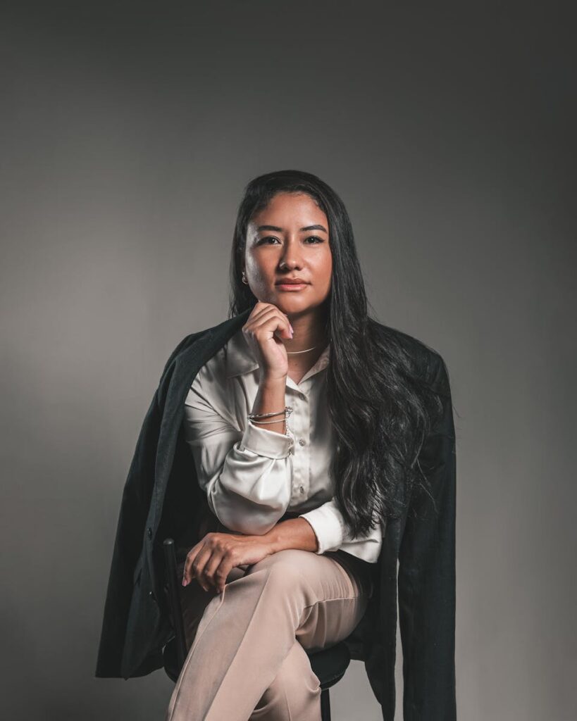 Portrait of a confident businesswoman in a studio setting, exuding professionalism and elegance.