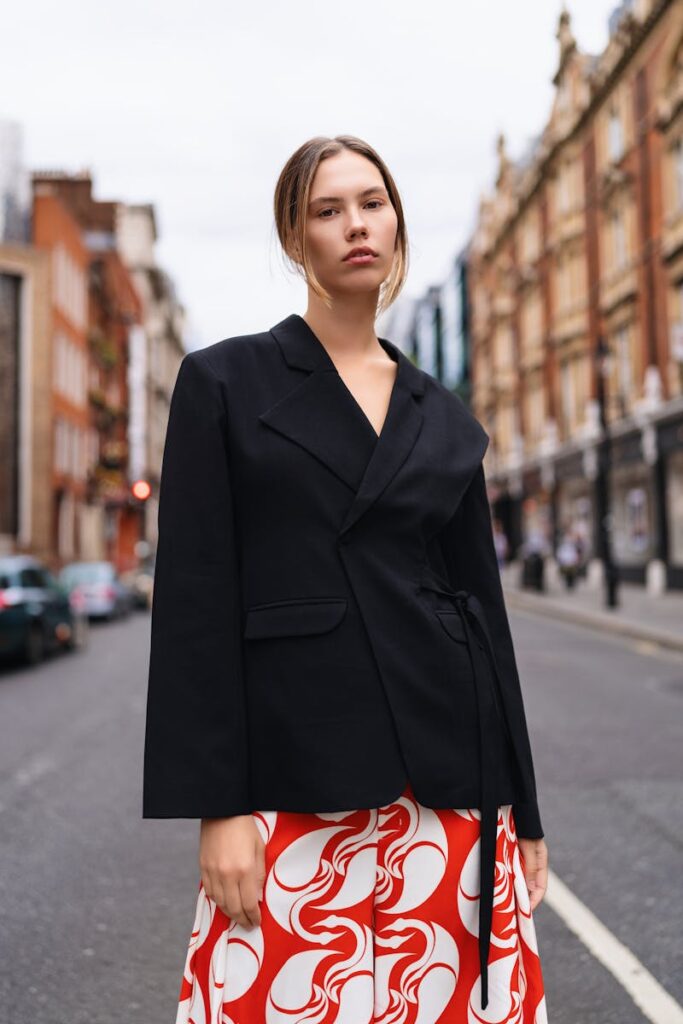 Stylish woman in a chic outfit posing on a street in London. Fashion and elegance.