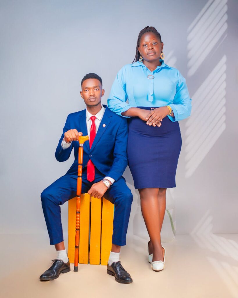 Formal portrait of two adults in business attire in a studio setting.