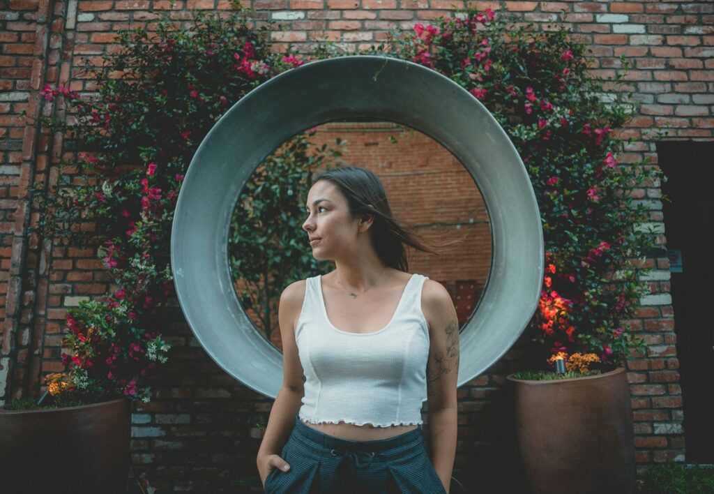 woman standing against round gray decor