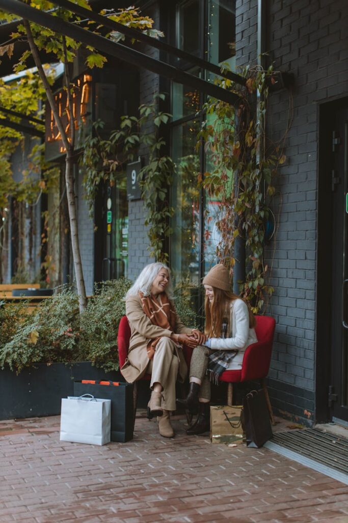 Senior woman and young girl enjoy bonding outdoors after shopping.