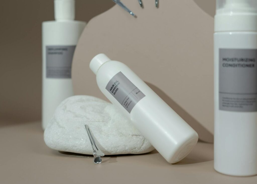 Close-up of various hair care products elegantly displayed with soft lighting for spa use.