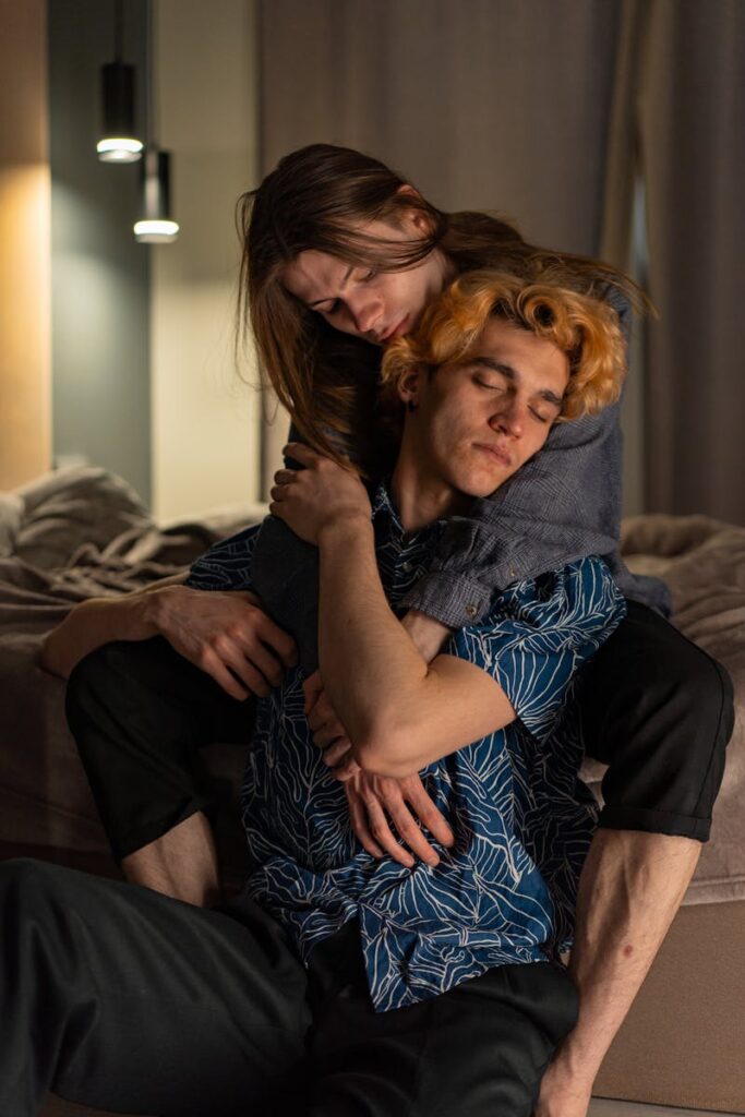 Loving couple embracing in a warm bedroom setting, filled with affection and tranquility.