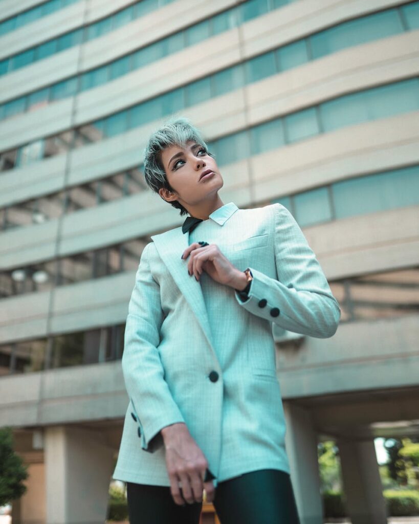 Fashionable woman with pixie cut looking afar in urban environment. Modern city style.