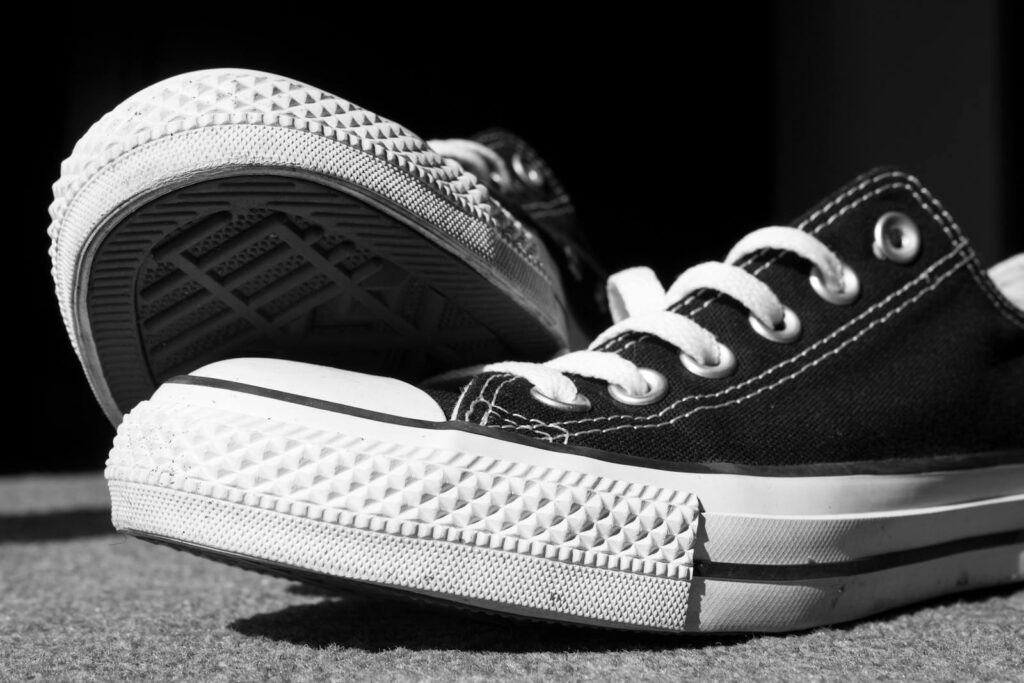 Stylish black and white photo of classic canvas sneakers highlighting textures.