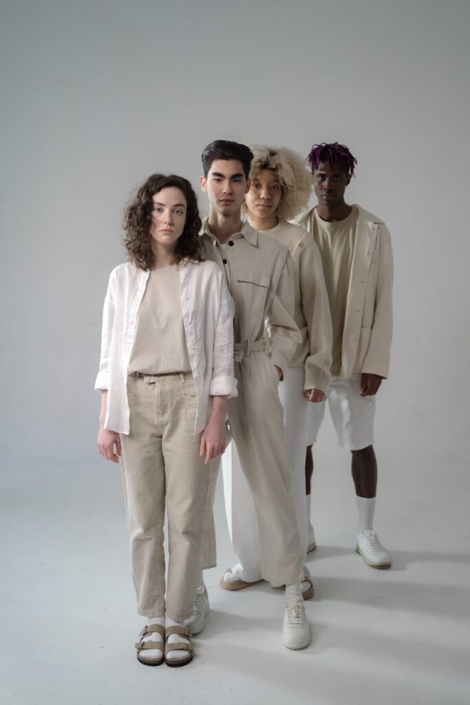 A stylish group of diverse models in neutral tones, set in a studio.