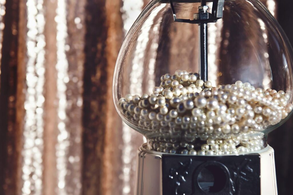 Close-up of pearls in a vintage dispenser with a blurred bokeh effect, creating a luxurious feel.
