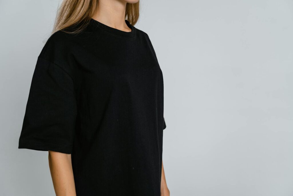 Side view of person in black t-shirt with copy space, ideal for mockups.