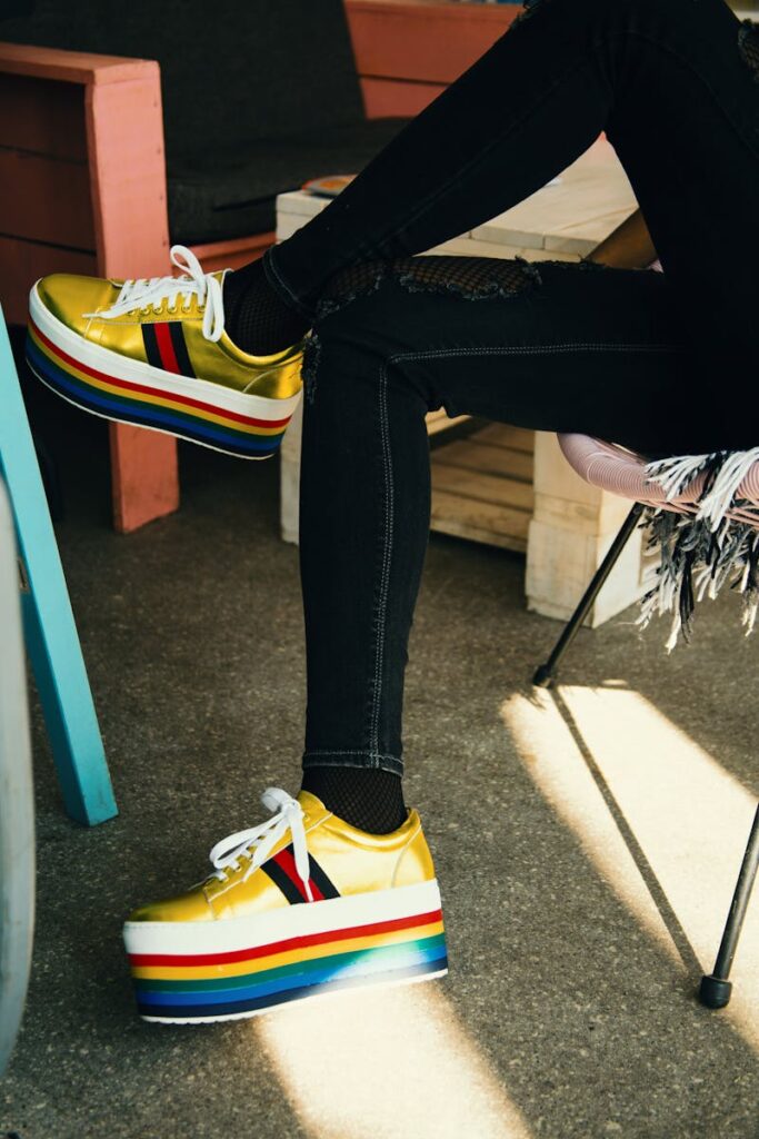 Fashion-forward platform sneakers with rainbow stripes in a stylish setting.