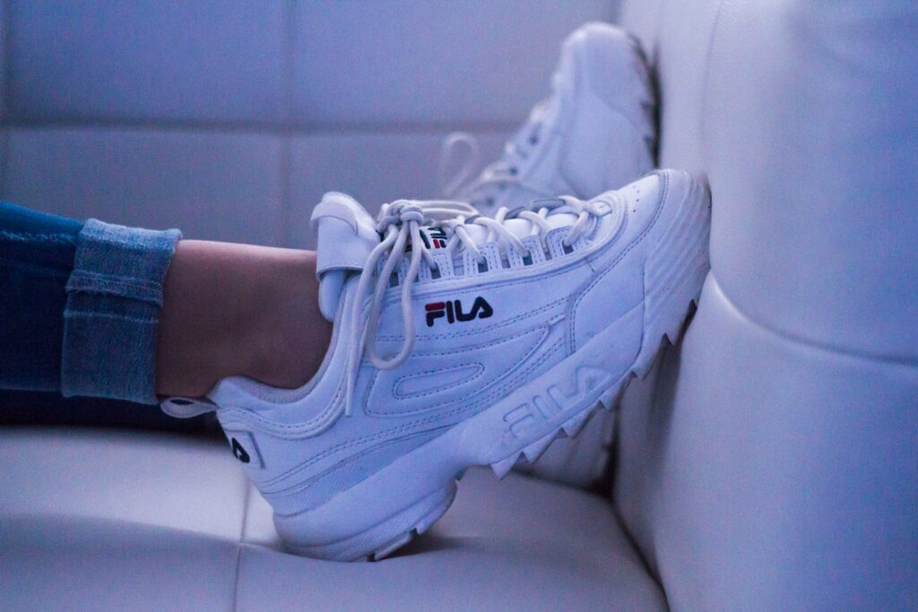 woman wearing white Fila shoes