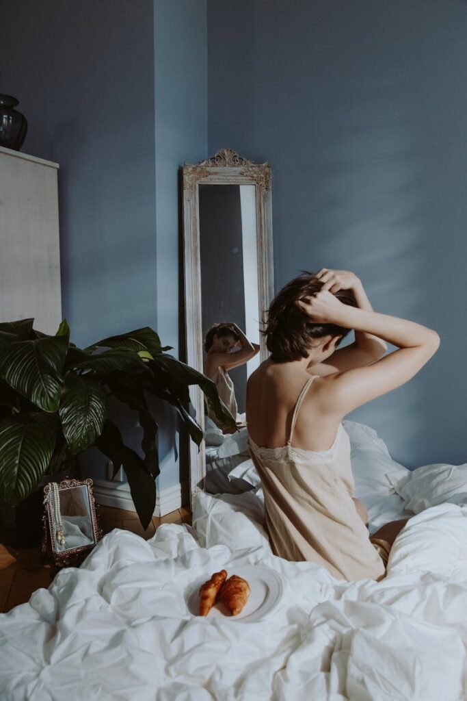 A serene morning scene in a bedroom with a person enjoying breakfast in bed.
