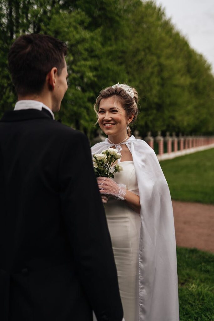 Happy couple enjoys a beautiful wedding day in a lush Moscow park, capturing romance and joy.
