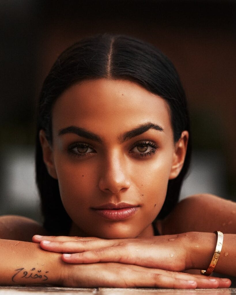 Elegant headshot of a woman with striking features and black hair.
