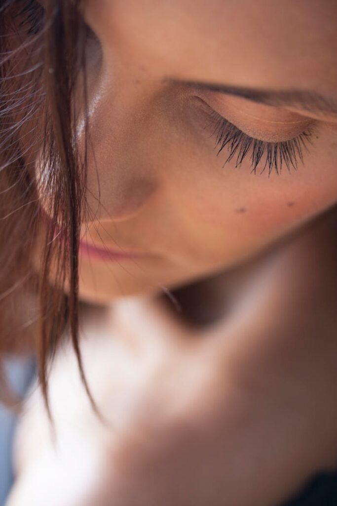 Close-up artistic portrait capturing a young woman's serene expression and natural beauty.