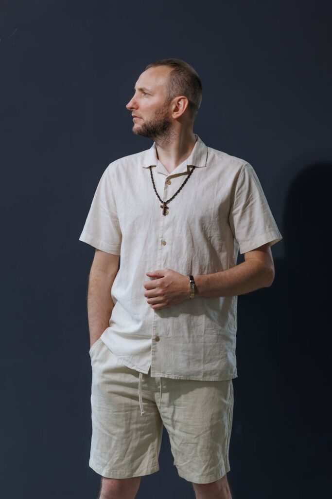 Portrait of a man in casual linen attire with a cross necklace, stylish and modern.