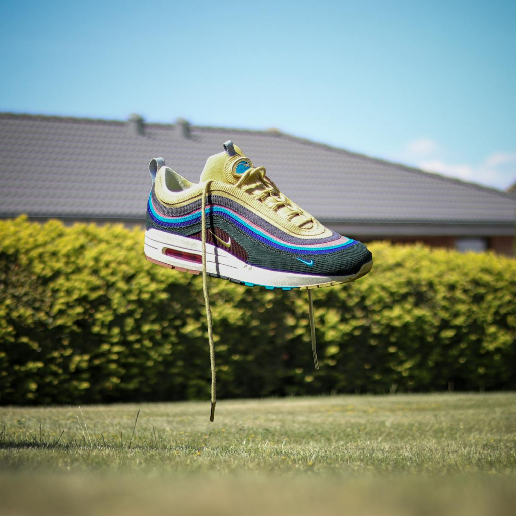 Nike sneaker floating above grass in a sunny Danish garden.