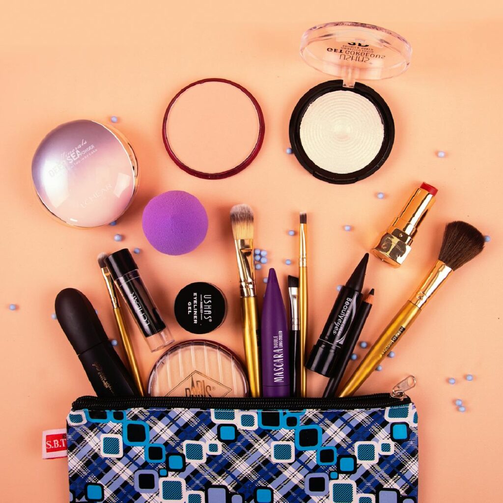 A vibrant assortment of makeup tools and products stylishly arranged on a peach background.