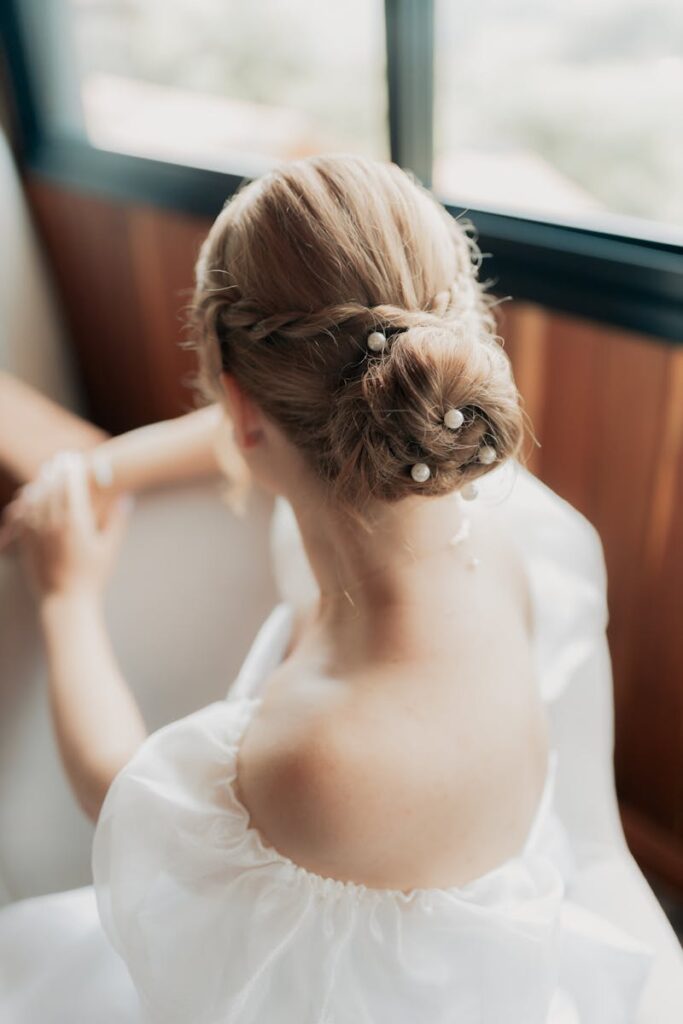 Close-up of an elegant bridal hairstyle adorned with pearls, capturing beauty and grace.
