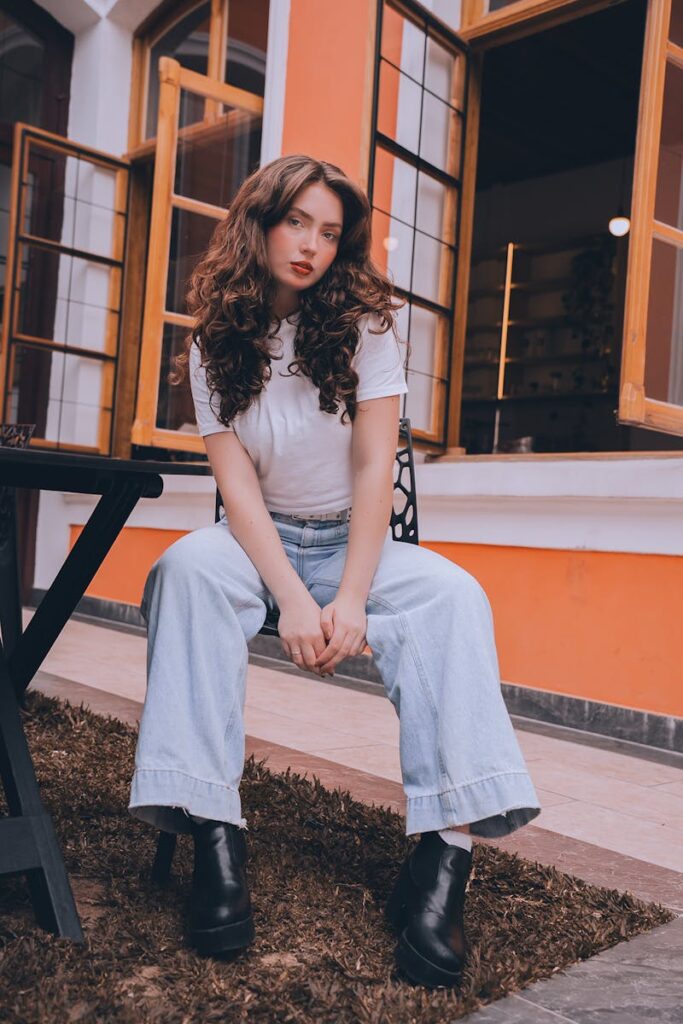 Fashionable woman poses outside a colorful building in Curitiba, Brazil.