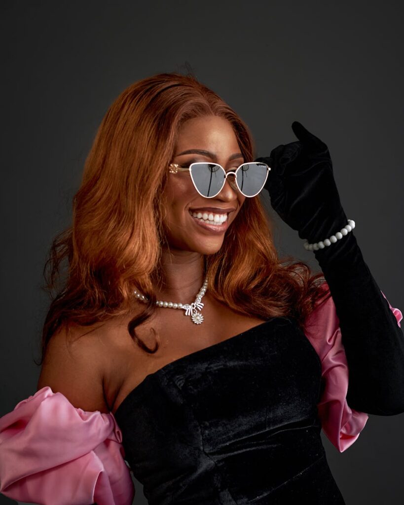 Confident woman in pink outfit posing with elegance for fashion and lifestyle photography.