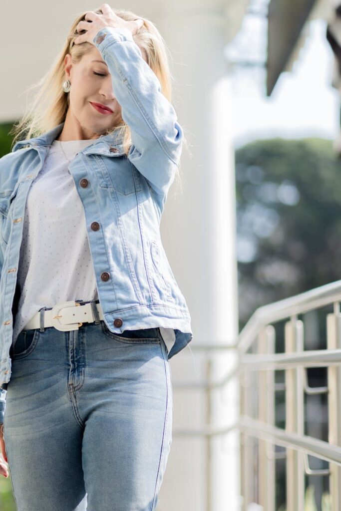 Casual portrait of a young woman outdoors, wearing denim, enjoying the sunny ambiance.