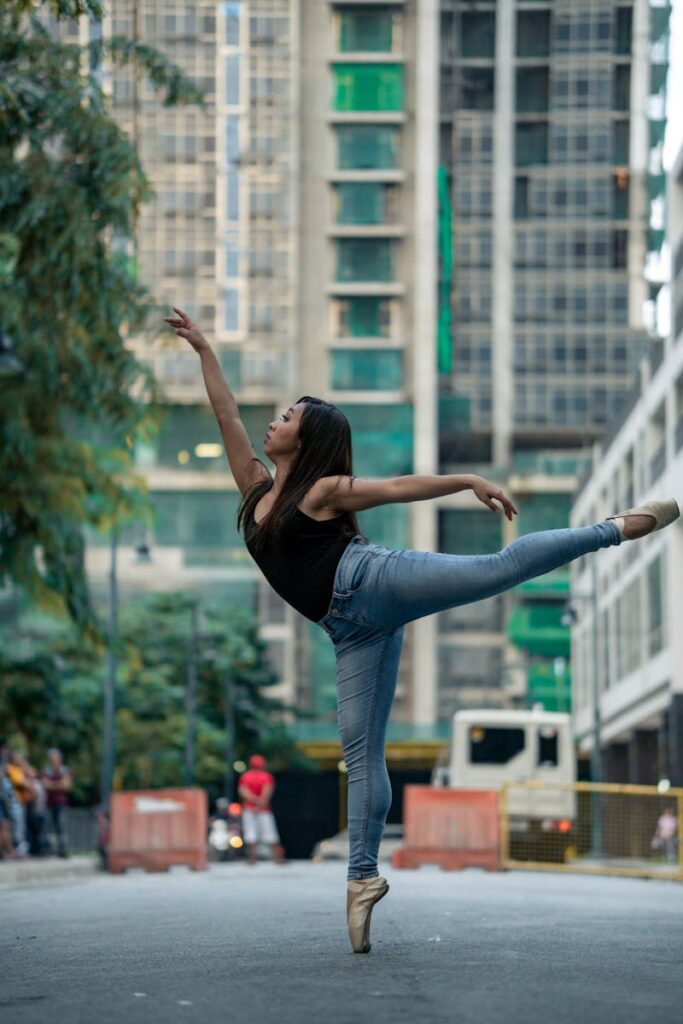 Ballet dancer striking a pose in a city street, blending art with urban life.