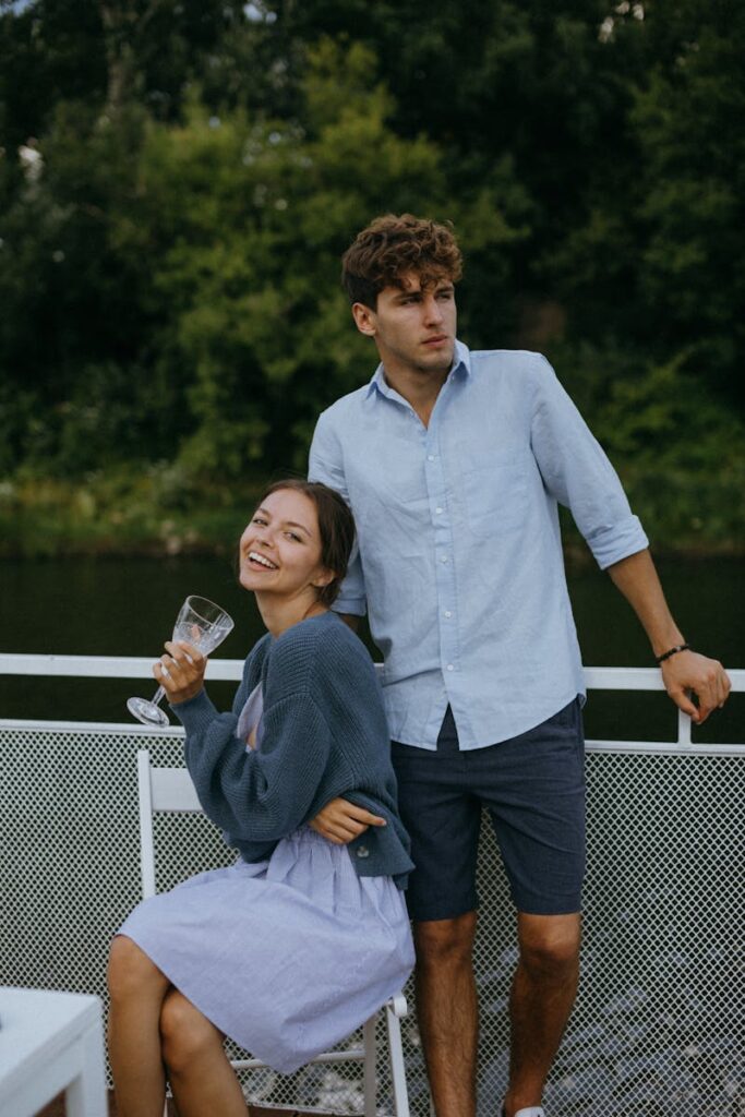 A young couple enjoys a summer day on a boat, featuring leisure and relaxation.