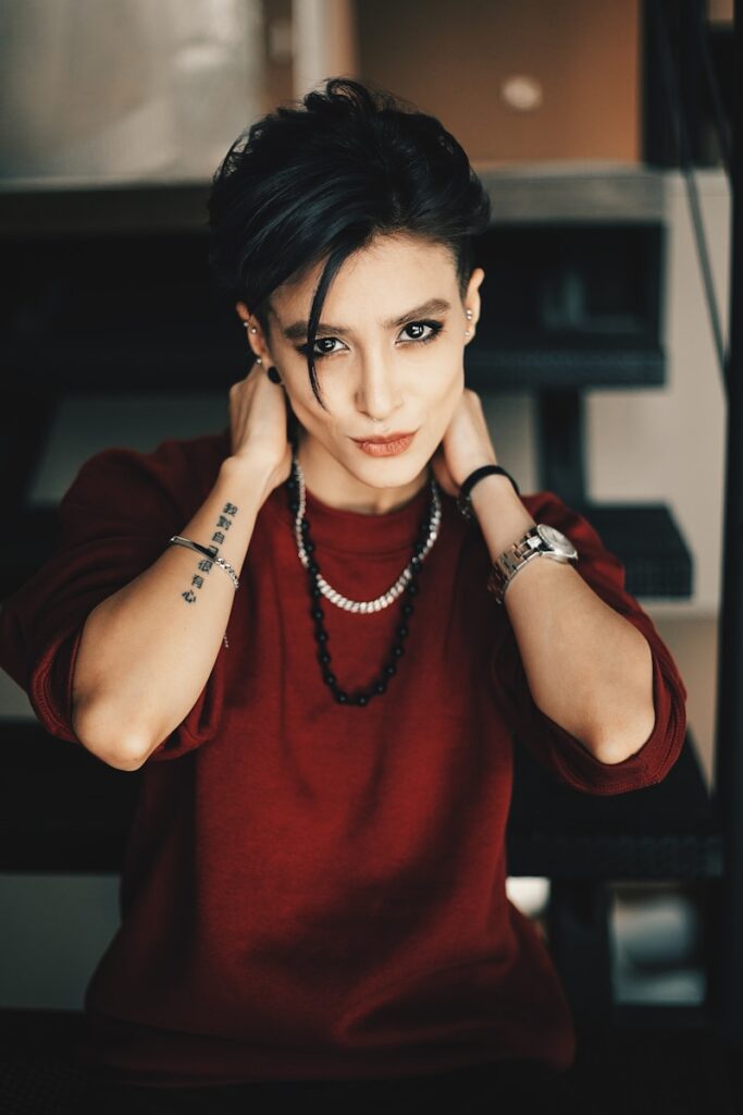 a woman in a red shirt with a tattoo on her arm