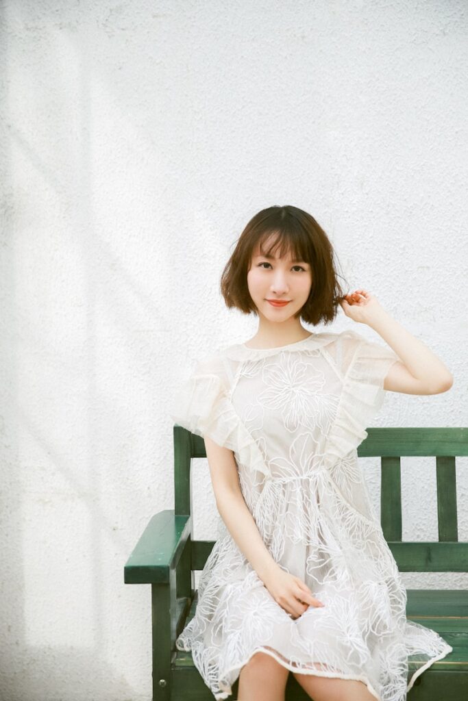 girl in white dress sitting on chair