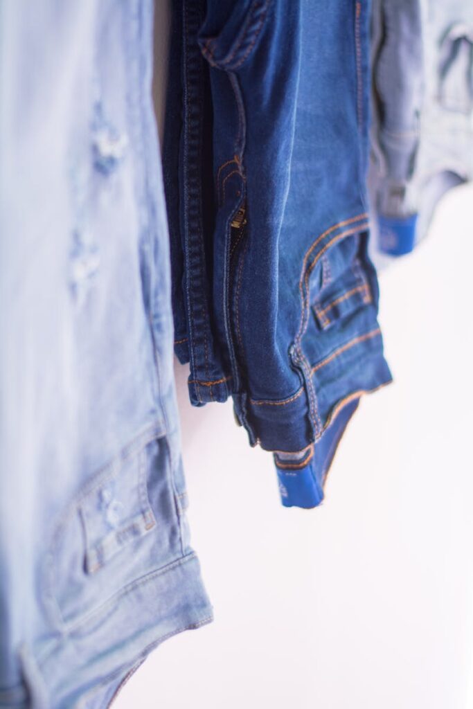 Artistic close-up of various shades of denim jeans, emphasizing texture and fashion style.