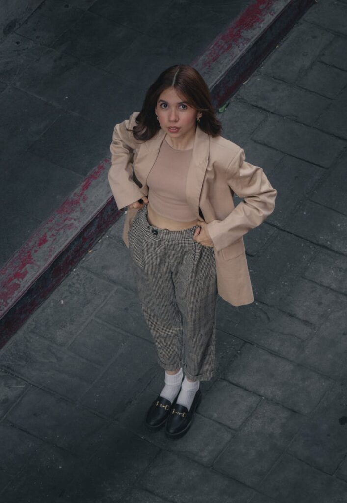Fashionable young woman looking up on a city sidewalk in CDMX, Mexico.