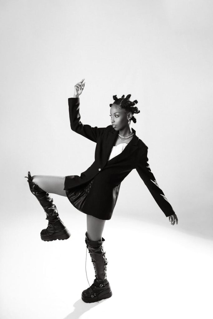 Dynamic fashion portrait of a woman posing against a white background in Brazil.