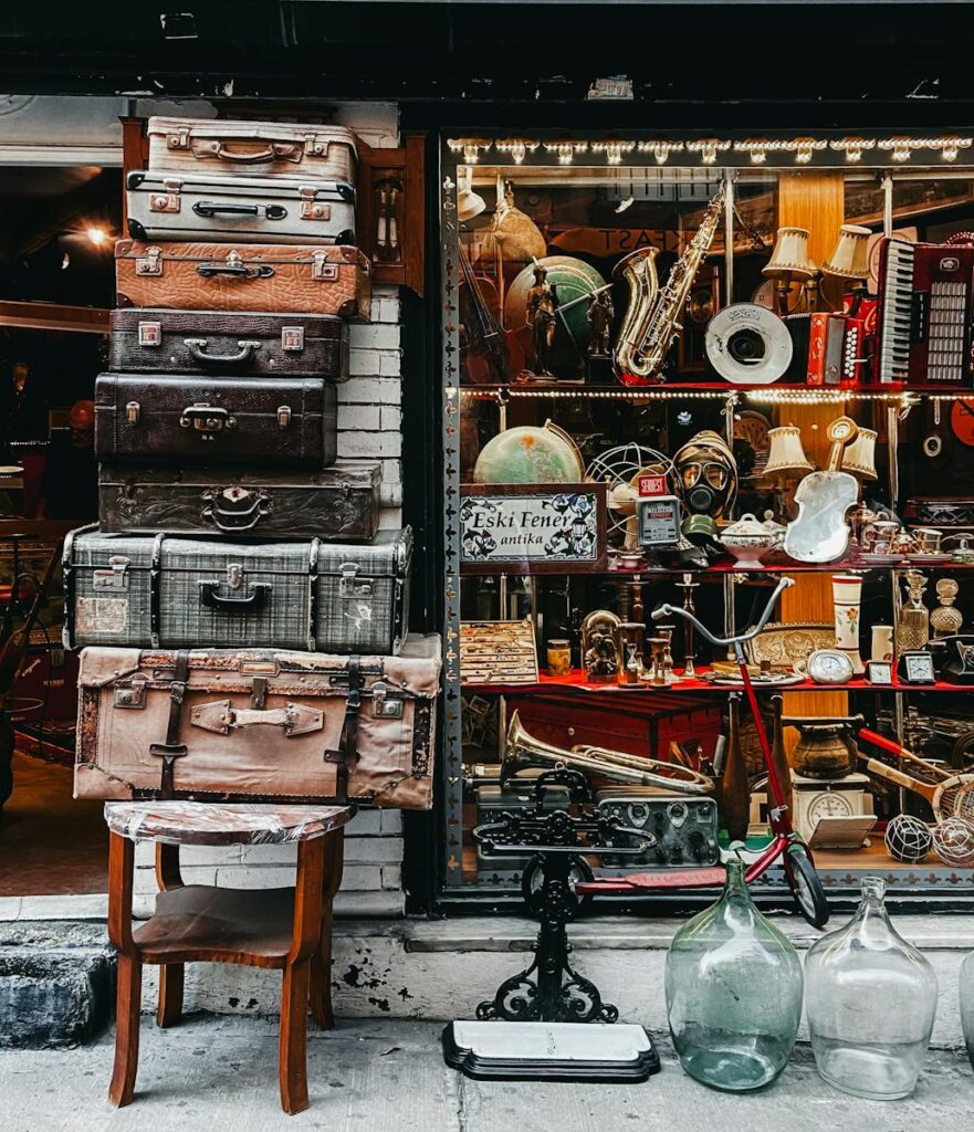 A collection of vintage suitcases and retro items displayed at an antique store.