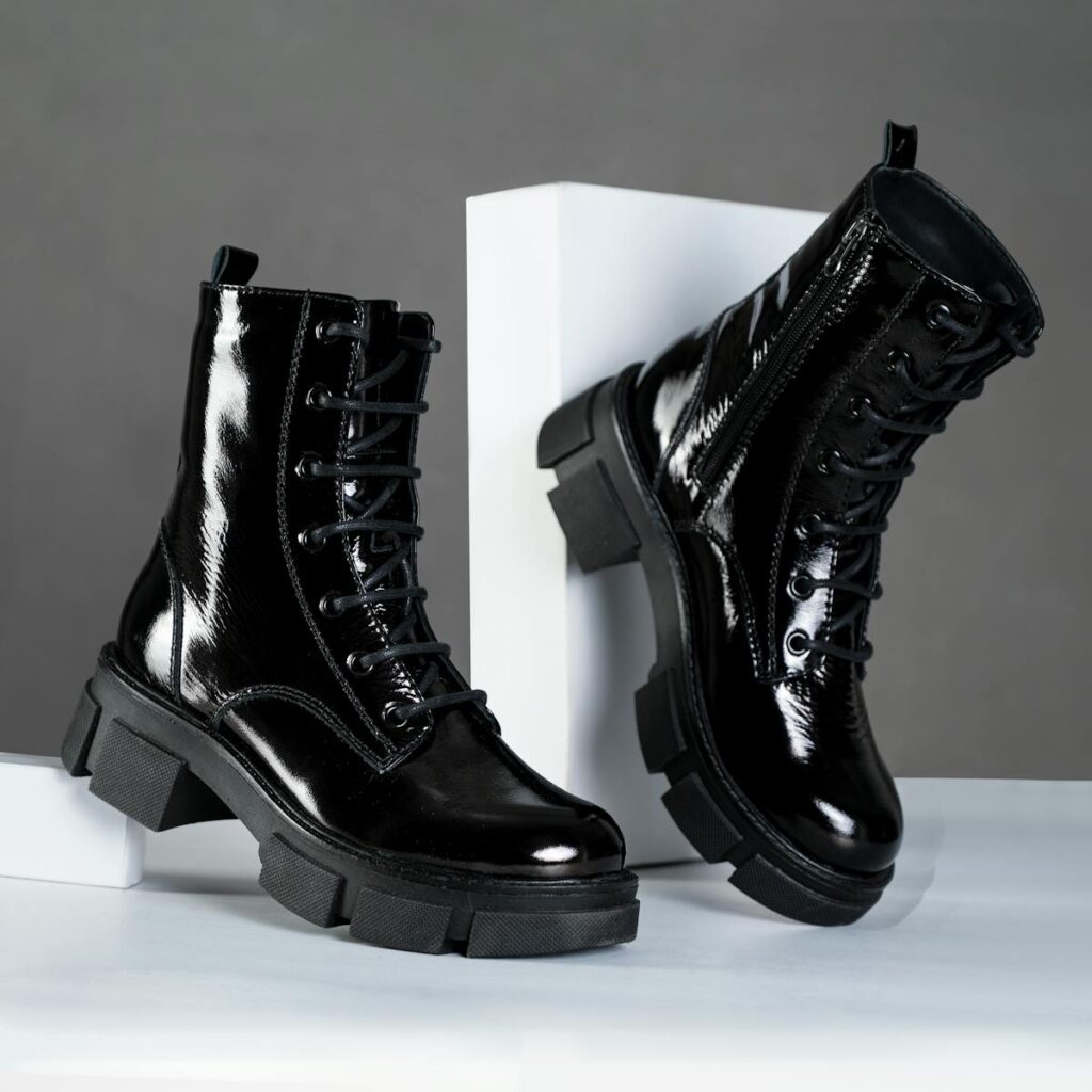 Stylish black leather lace-up boots showcased in an elegant studio setting.