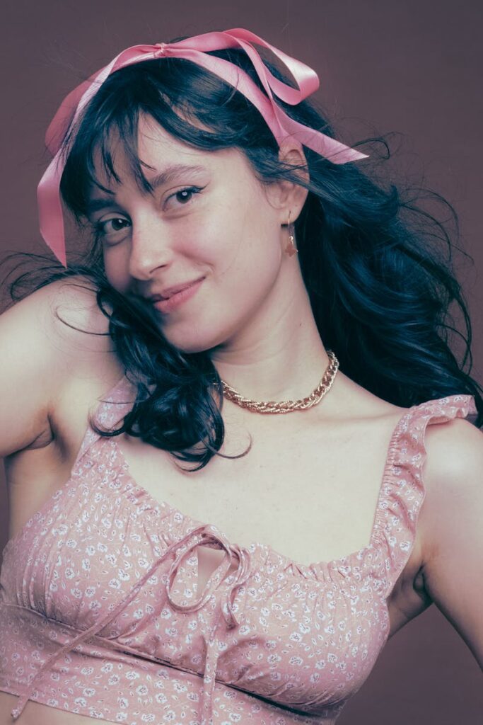 Elegant female portrait with a playful pink bow, captured in São Paulo.