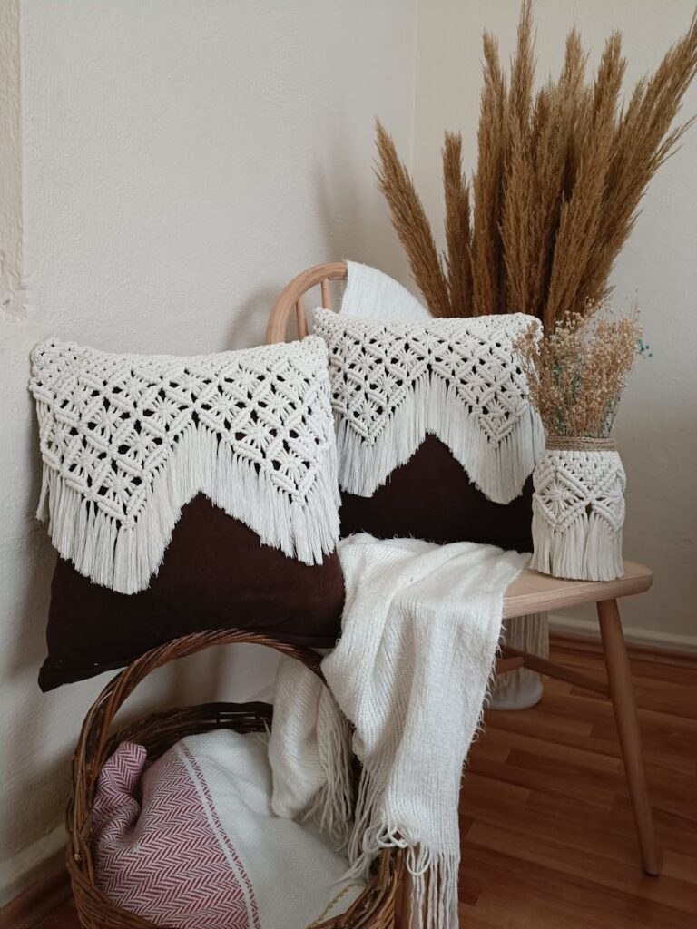 Stylish bohemian corner featuring crochet pillows and natural decor elements in a cozy setup.