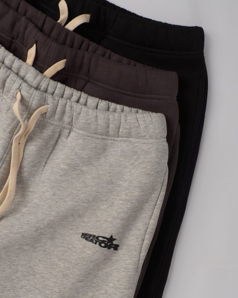 A top-down view of folded sweatpants in various colors, showcasing casual fashion options.